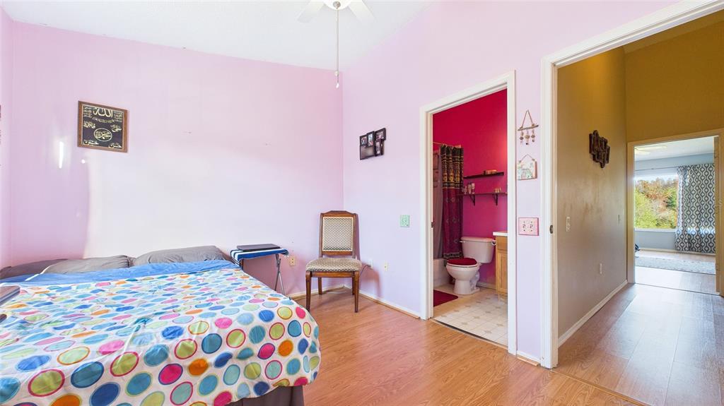 1250 Redondo Way Wesley Chapel, FL 33543 - Photo 16 of 27 a bedroom with a bed and a table in it