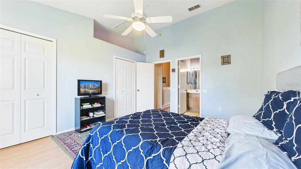 1250 Redondo Way Wesley Chapel, FL 33543 - Photo 21 of 27 a bedroom with a bed and a chandelier