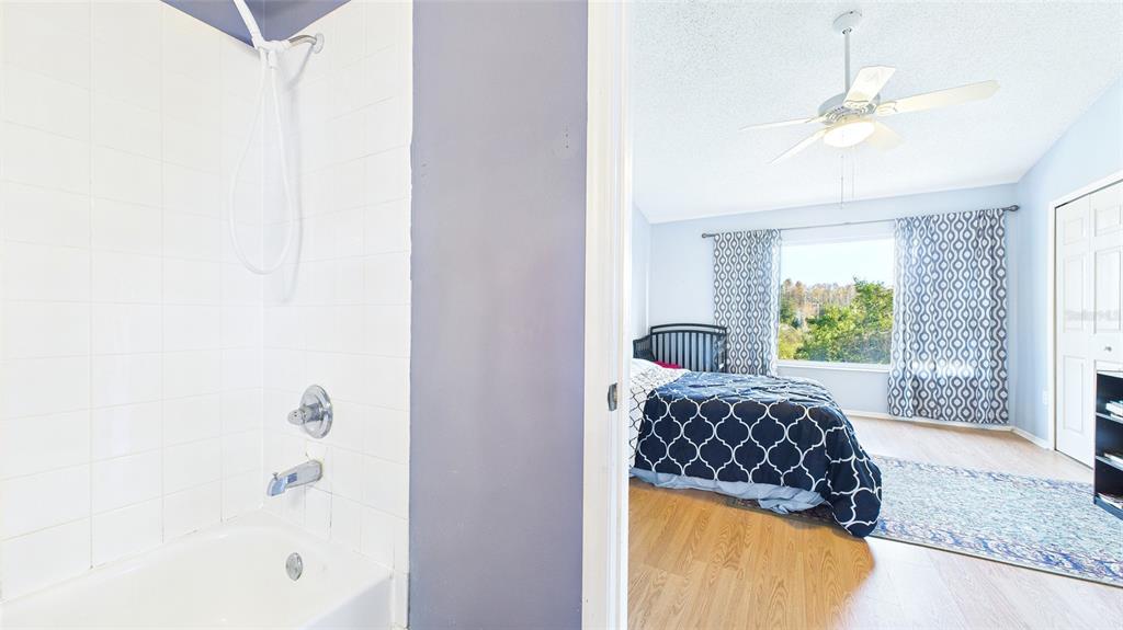 1250 Redondo Way Wesley Chapel, FL 33543 - Photo 24 of 27 a bedroom with a bed and a window with a potted plant