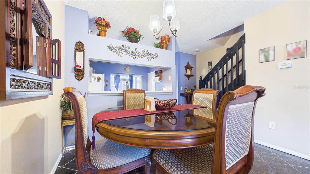 1250 Redondo Way Wesley Chapel, FL 33543 - Photo 7 of 27 a dining room with furniture and wooden floor
