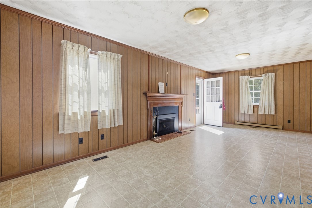 10215 River Road Petersburg, VA 23803 - Photo 15 of 31 Wood-paneled walls featuring multiple windows