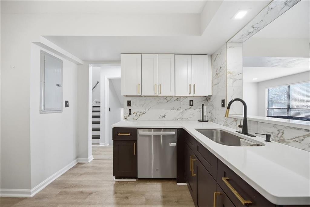 1039 Mariners Court Stone Mountain, GA 30083 - Photo 12 of 60 a view of a kitchen with sink a stove and furniture