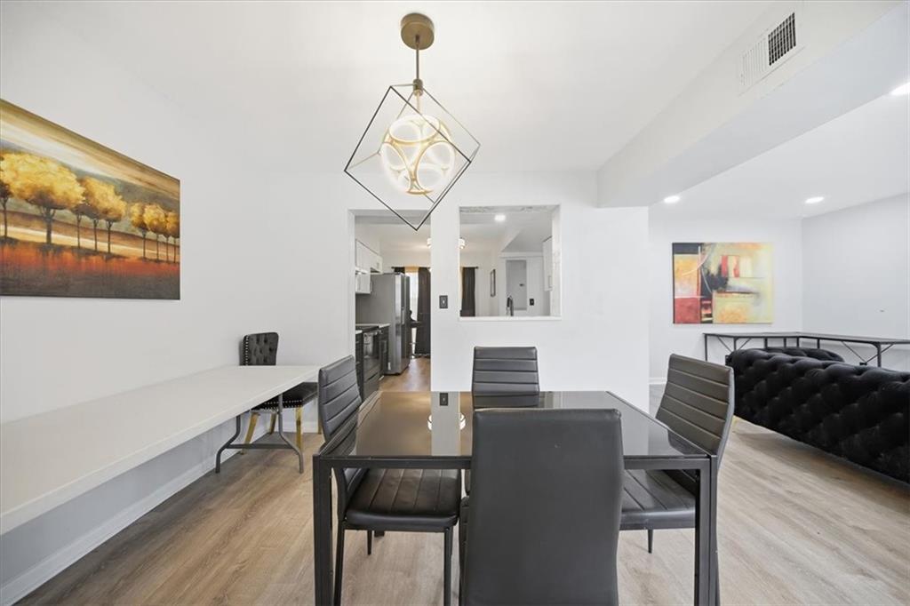 1039 Mariners Court Stone Mountain, GA 30083 - Photo 16 of 60 a view of a dining room with furniture wooden floor and chandelier