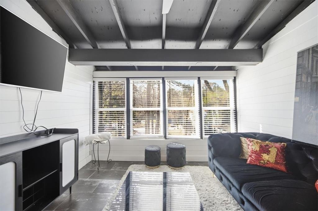 1039 Mariners Court Stone Mountain, GA 30083 - Photo 17 of 60 a living room with furniture and a flat screen tv