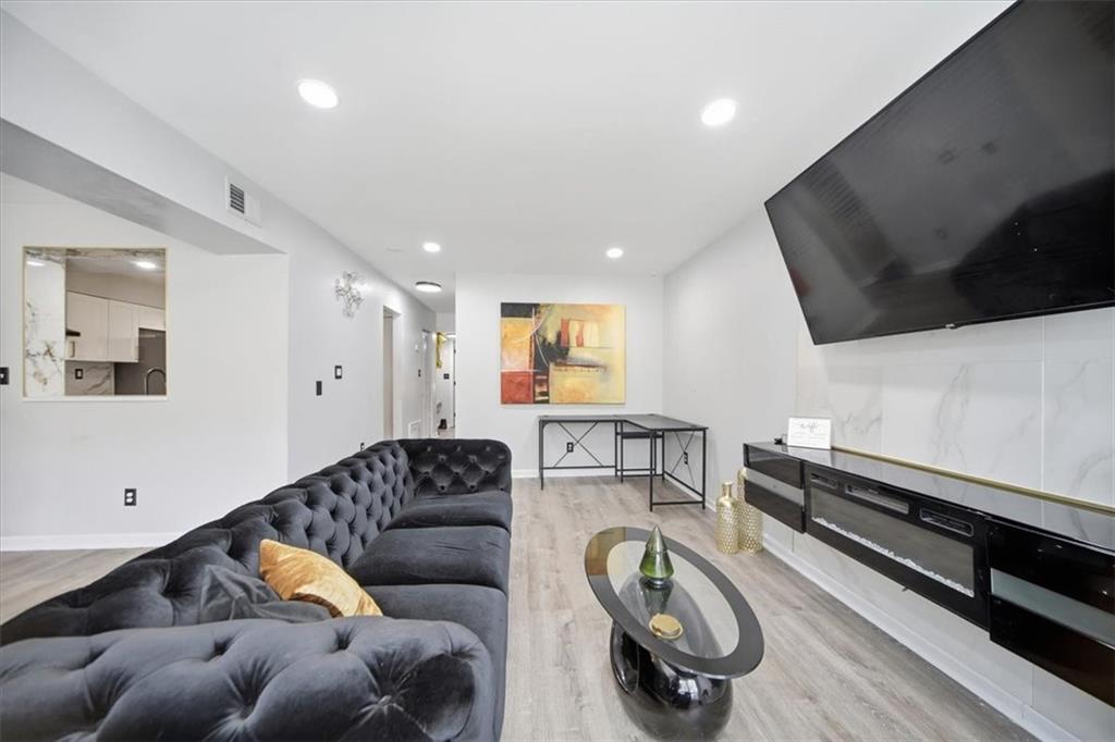 1039 Mariners Court Stone Mountain, GA 30083 - Photo 23 of 60 a living room with furniture and a flat screen tv