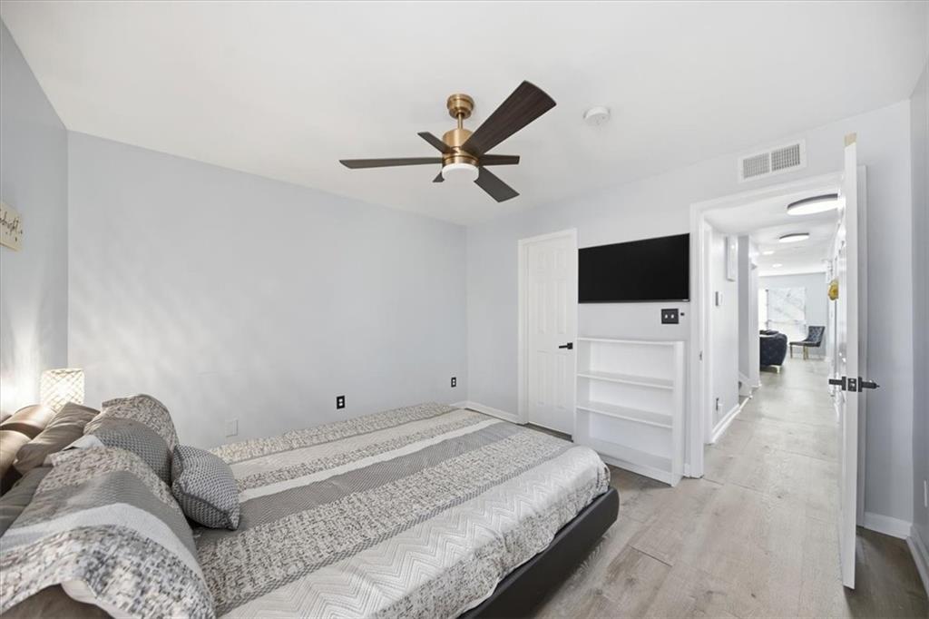 1039 Mariners Court Stone Mountain, GA 30083 - Photo 27 of 60 a spacious bedroom with a bed and a flat screen tv
