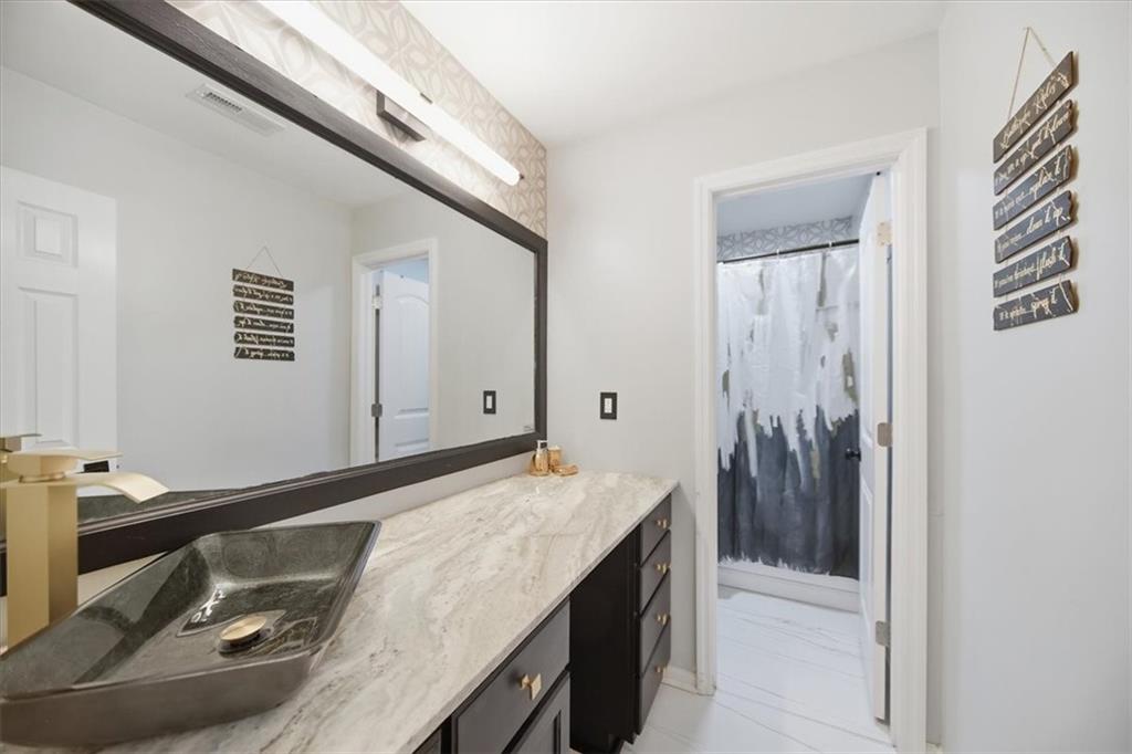 1039 Mariners Court Stone Mountain, GA 30083 - Photo 31 of 60 a bathroom with a sink and a mirror