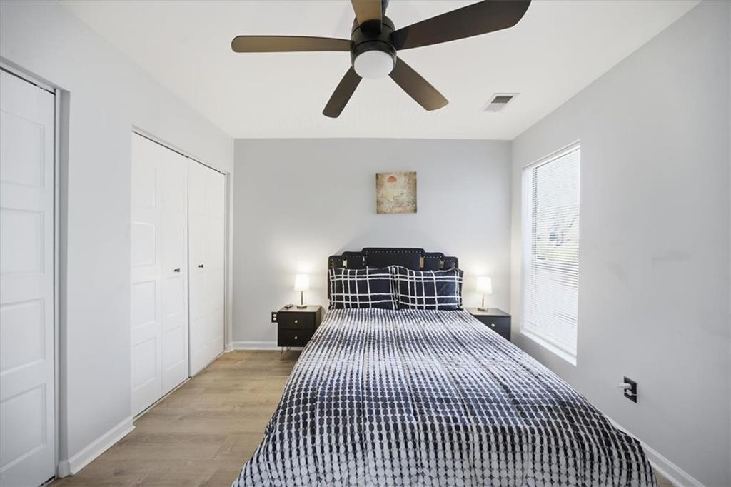 1039 Mariners Court Stone Mountain, GA 30083 - Photo 33 of 60 a bedroom with a bed and painting on the wall