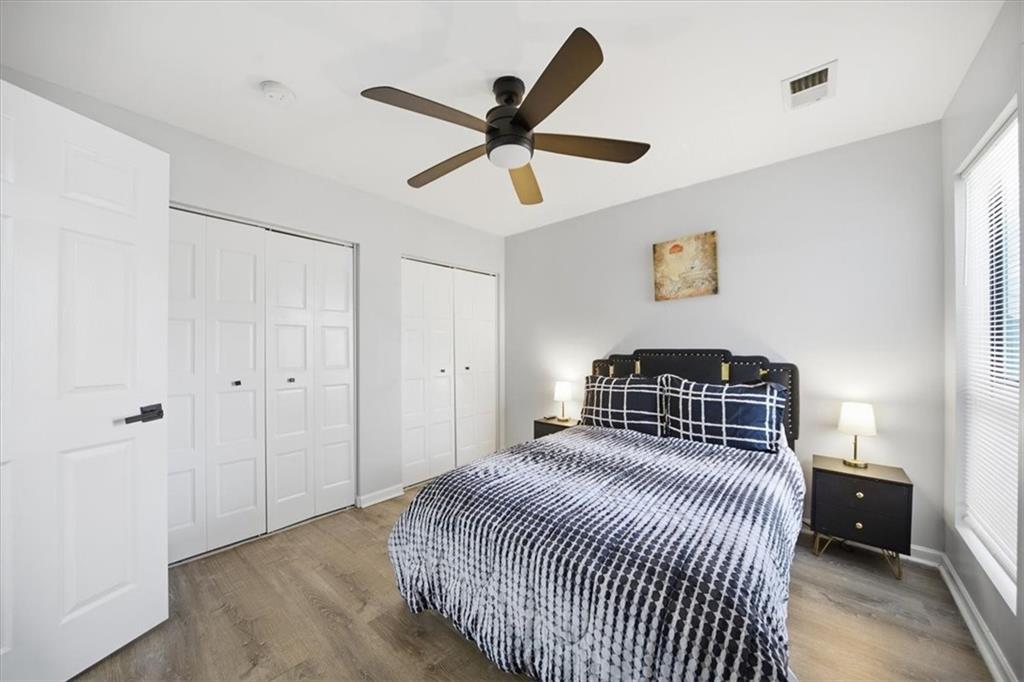 1039 Mariners Court Stone Mountain, GA 30083 - Photo 34 of 60 a bedroom with a bed and a ceiling fan