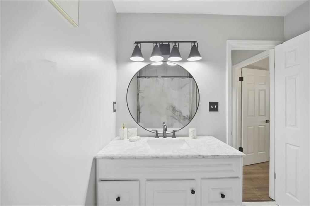 1039 Mariners Court Stone Mountain, GA 30083 - Photo 36 of 60 a bathroom with a sink and a mirror
