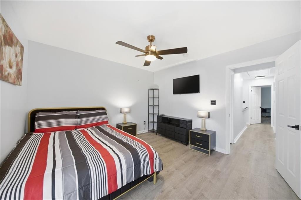 1039 Mariners Court Stone Mountain, GA 30083 - Photo 39 of 60 a bedroom with a bed and a flat screen tv