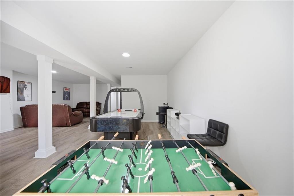 1039 Mariners Court Stone Mountain, GA 30083 - Photo 48 of 60 a living room with furniture and a wooden floor