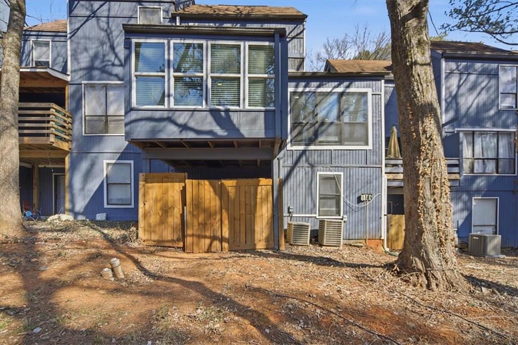 1039 Mariners Court Stone Mountain, GA 30083 - Photo 54 of 60 a view of a house with a large window and a yard