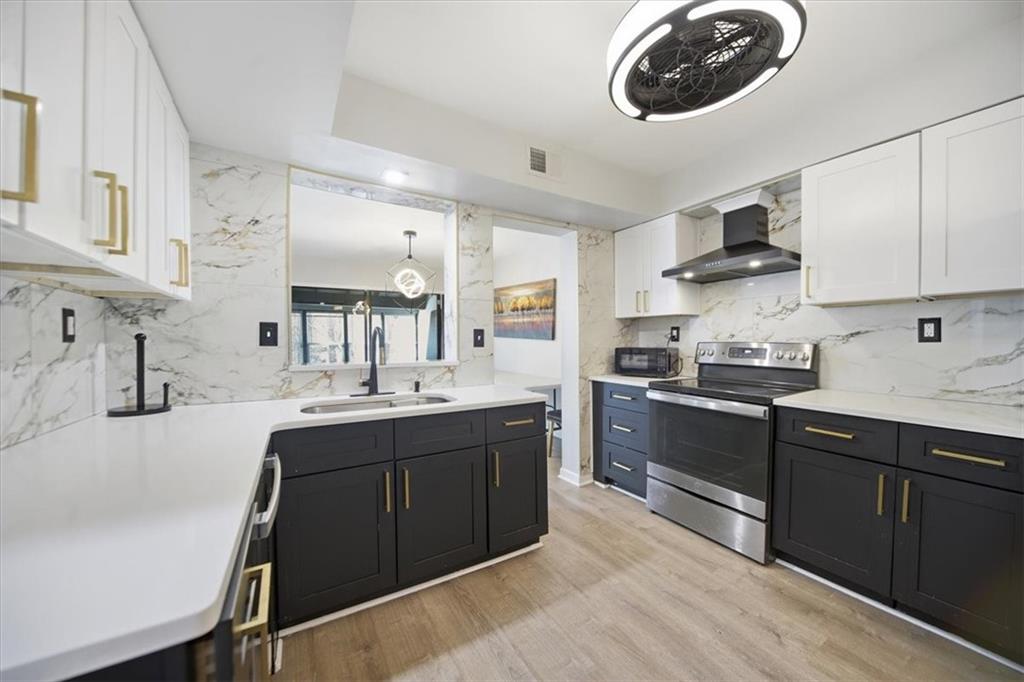 1039 Mariners Court Stone Mountain, GA 30083 - Photo 10 of 60 a kitchen with stainless steel appliances granite countertop a sink and stove top oven