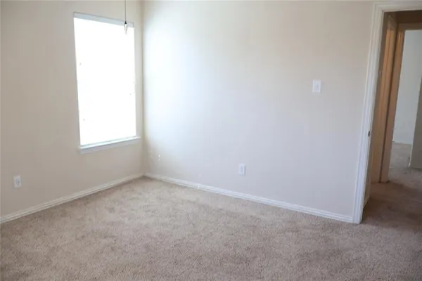 an empty room that has a grey walls