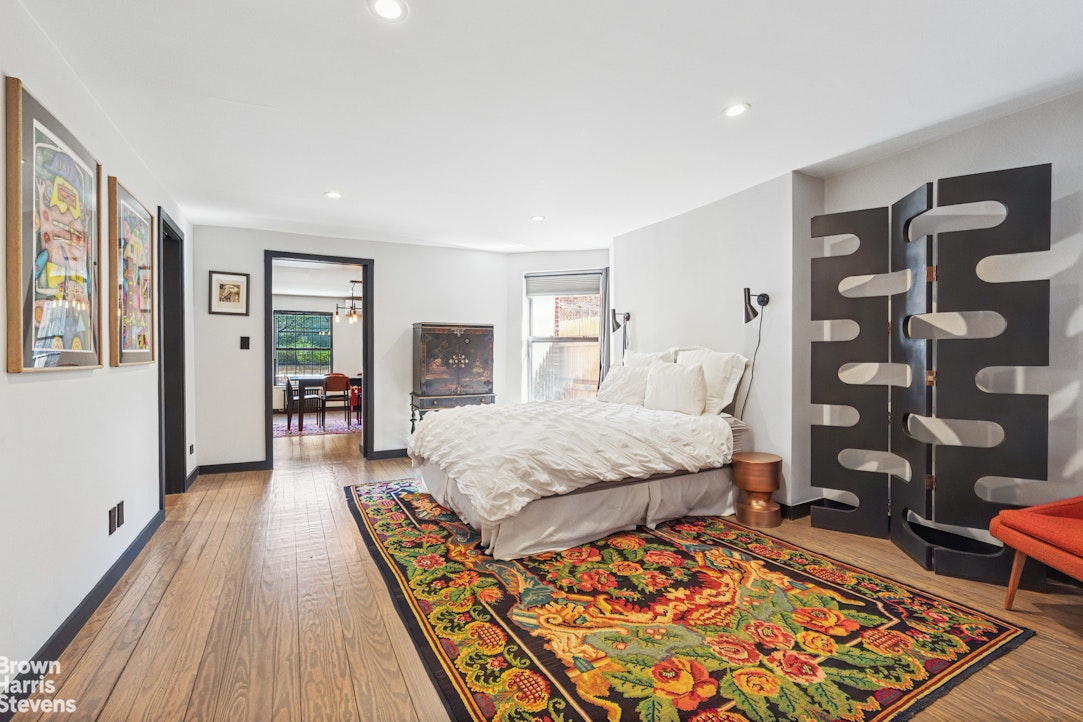 7 East 129th Street Manhattan, NY 10035 - Photo 13 of 24 a spacious bedroom with a bed and wooden floor