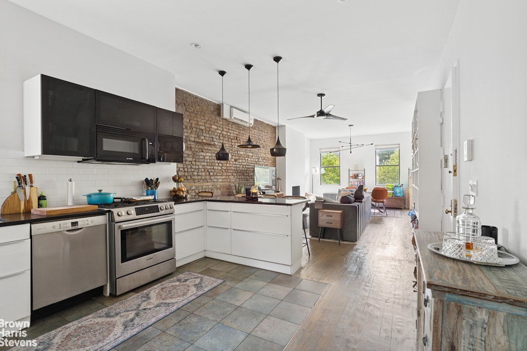 7 East 129th Street Manhattan, NY 10035 - Photo 15 of 24 a kitchen with a sink stove and microwave