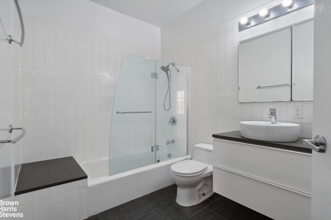 7 East 129th Street Manhattan, NY 10035 - Photo 16 of 24 a bathroom with a granite countertop sink toilet and shower