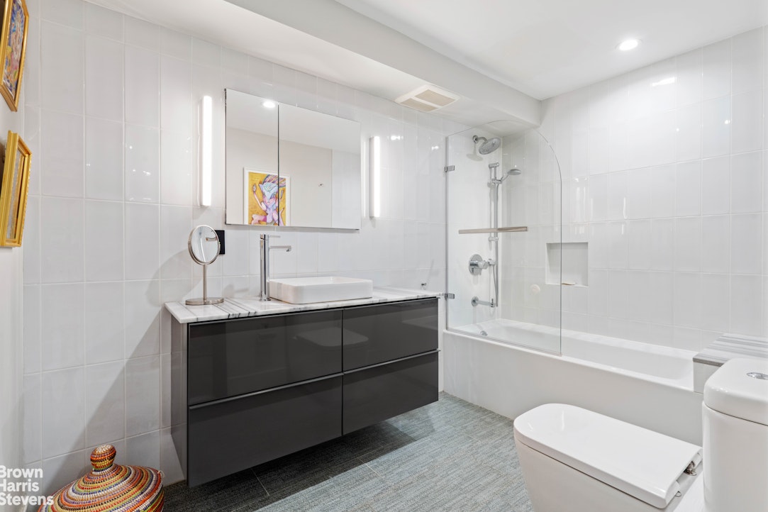 7 East 129th Street Manhattan, NY 10035 - Photo 20 of 24 a bathroom with a sink a toilet and bathtub