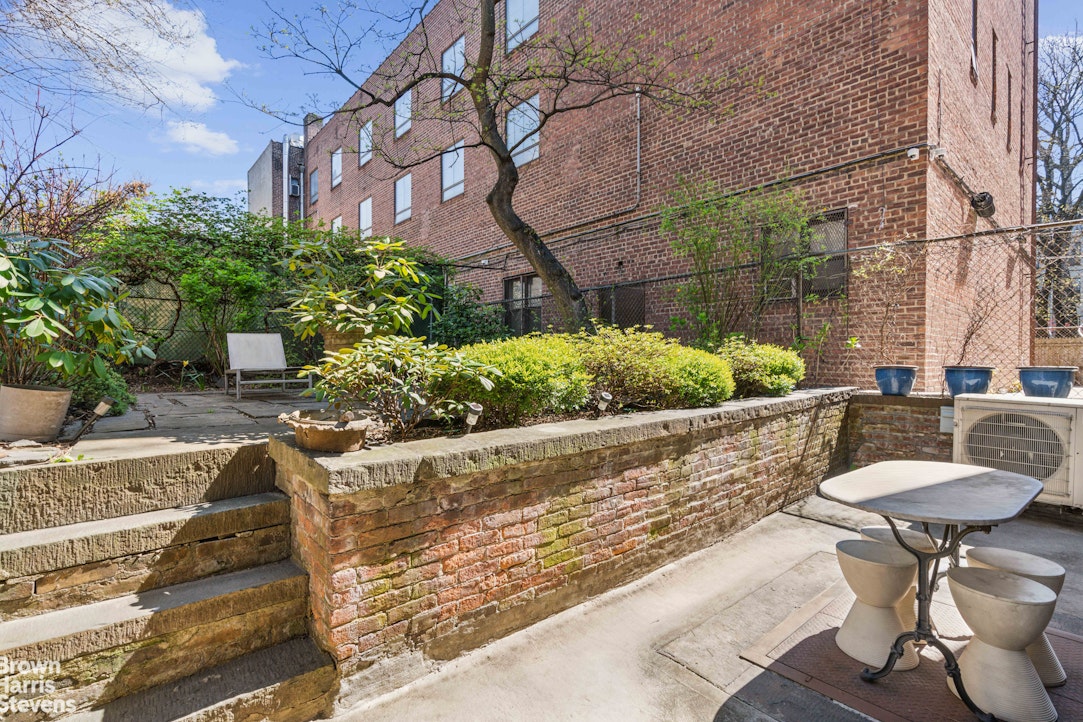 7 East 129th Street Manhattan, NY 10035 - Photo 22 of 24 a patio with table and chairs and potted plants