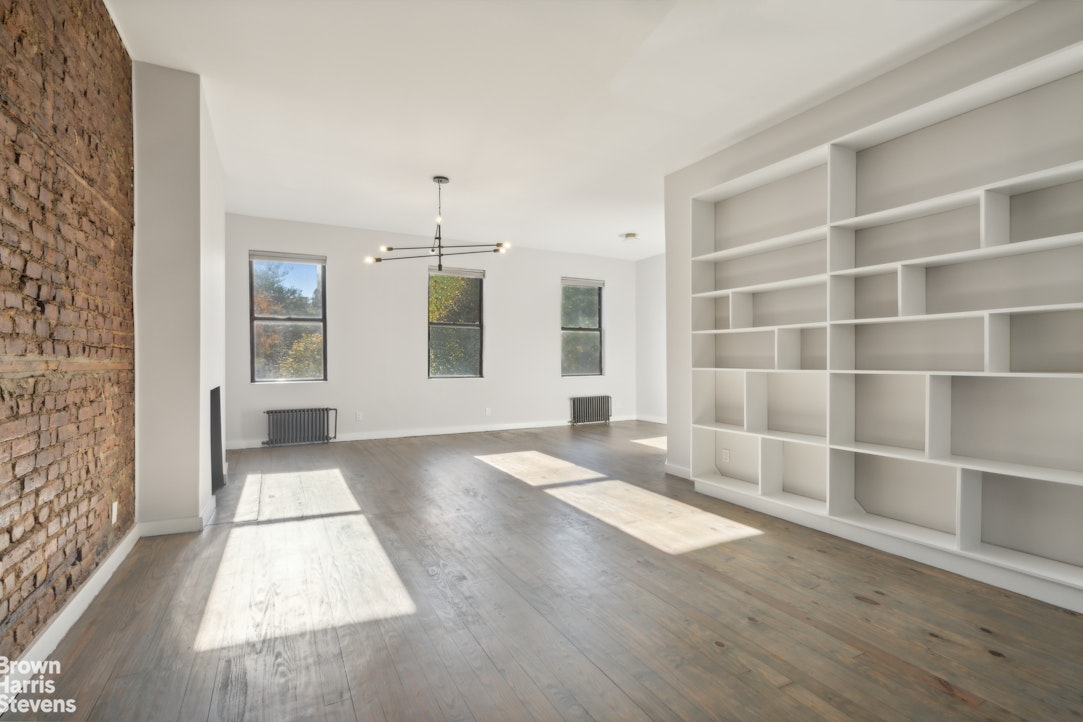 7 East 129th Street Manhattan, NY 10035 - Photo 2 of 24 a view of an empty room with wooden floor and a window