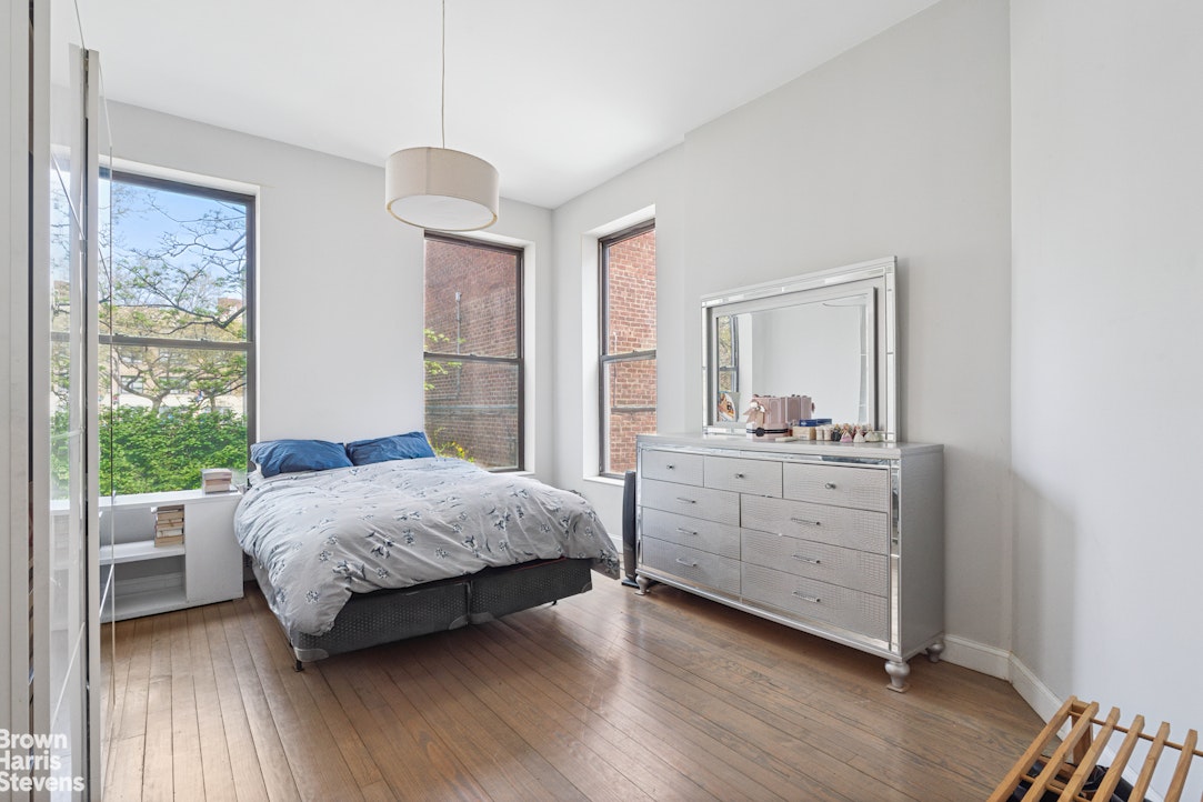 7 East 129th Street Manhattan, NY 10035 - Photo 6 of 24 a room with a bed and a dresser