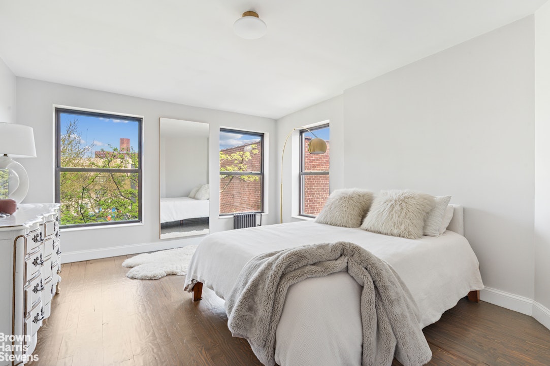 7 East 129th Street Manhattan, NY 10035 - Photo 7 of 24 a spacious bedroom with a bed and a window