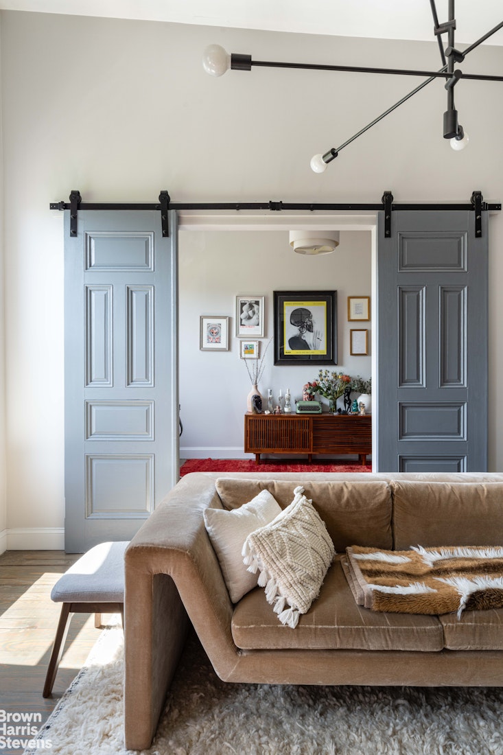 7 East 129th Street Manhattan, NY 10035 - Photo 8 of 24 a living room with furniture and a wooden floor