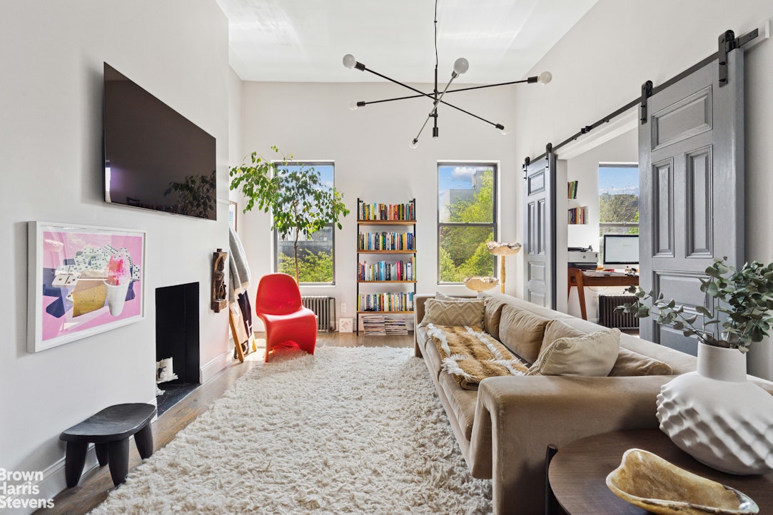 7 East 129th Street Manhattan, NY 10035 - Photo 9 of 24 a living room with furniture or flat screen tv and a large window