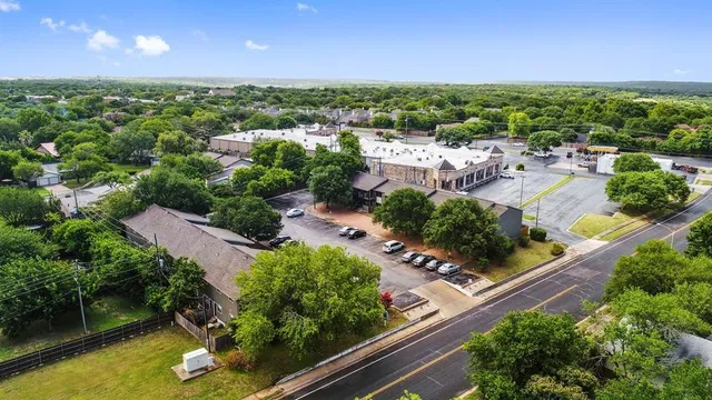 an aerial view of residential houses with outdoor space and swimming pool