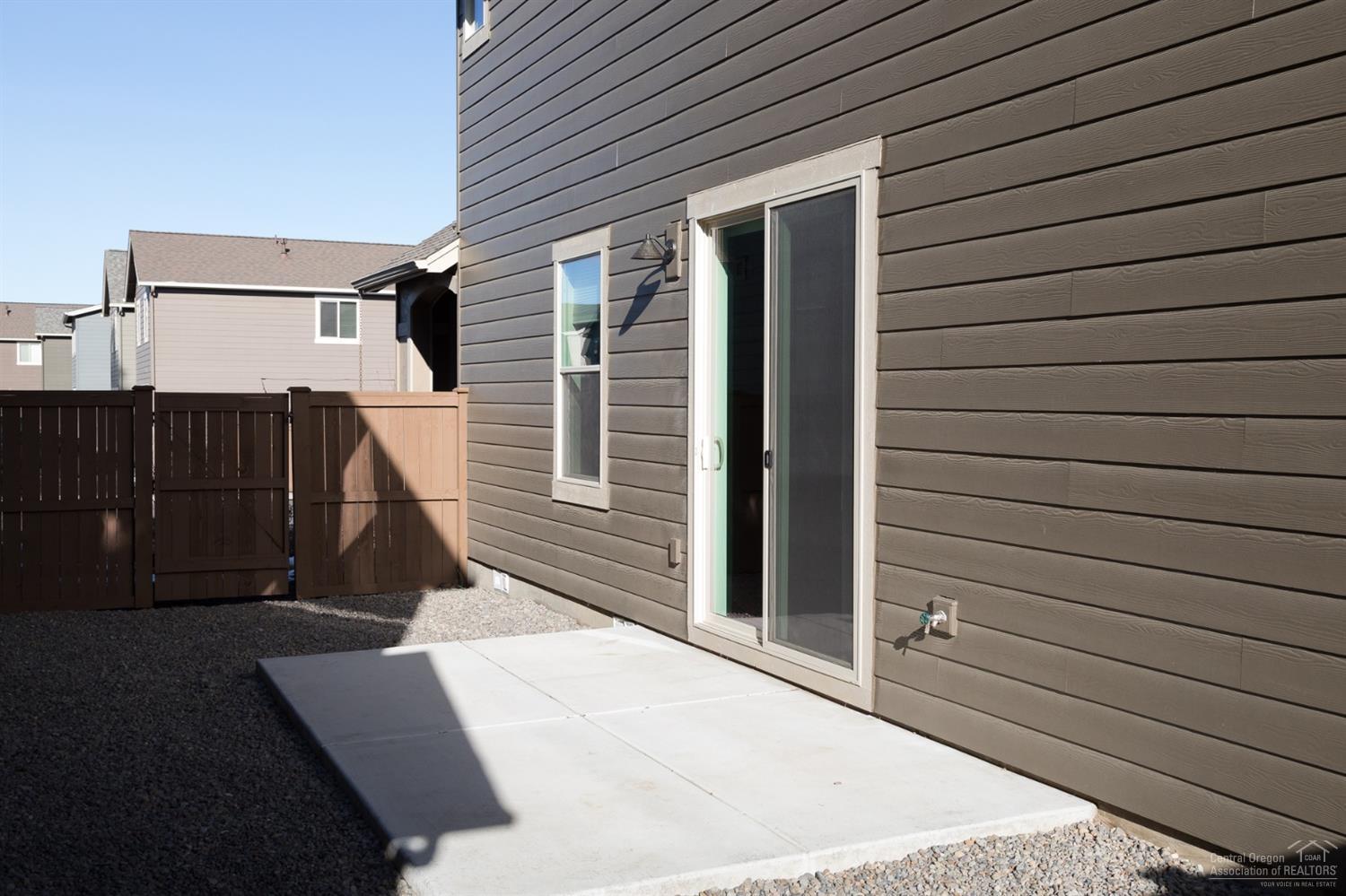 20945 Sotra Loop Bend, OR 97702 - Photo 18 of 25 Side yard with concrete pad, water spigo