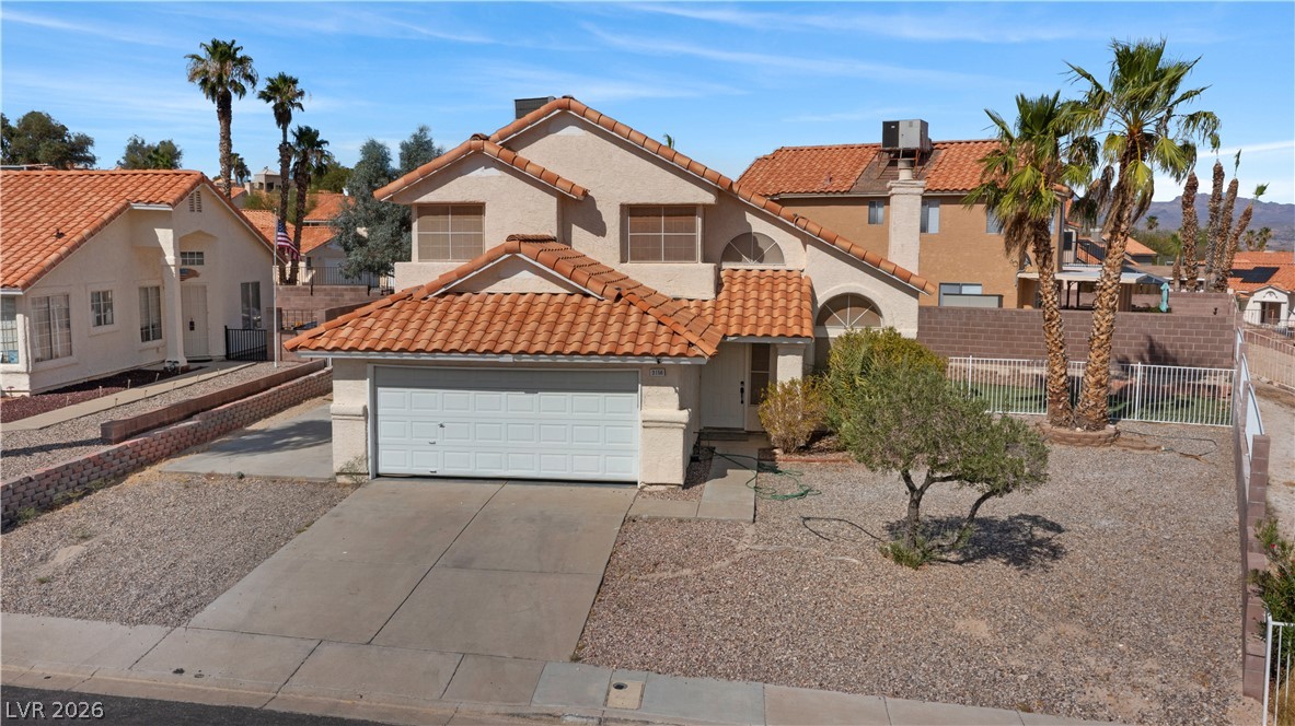 3156 Terrace View Drive Laughlin, NV 89029 - Photo 73 of 94 A terracotta-tiled roof crowns this residence, featuring an attached garage and desert-friendly landscaping.