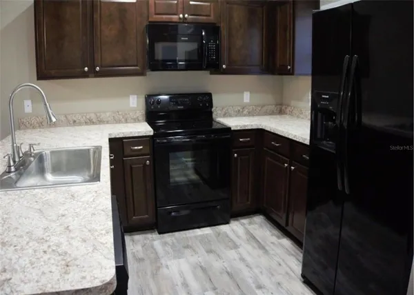 a kitchen with a sink and cabinets