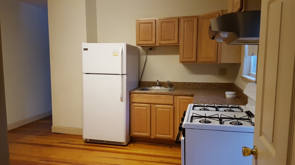 634 2nd Street Fall River, MA 02721 - Photo 3 of 12 a kitchen with a refrigerator and a stove