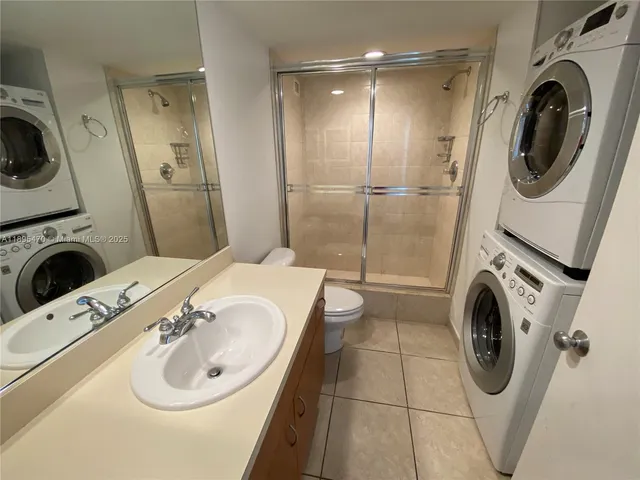 a living room with furniture a chandelier and a large window