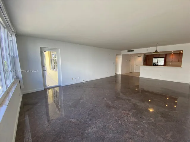 a view of a balcony with chairs and potted plants
