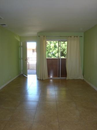 2857 North Los Felices Road, Unit 217 Palm Springs, CA 92262 - Photo 2 of 12 an empty room with wooden floor and windows