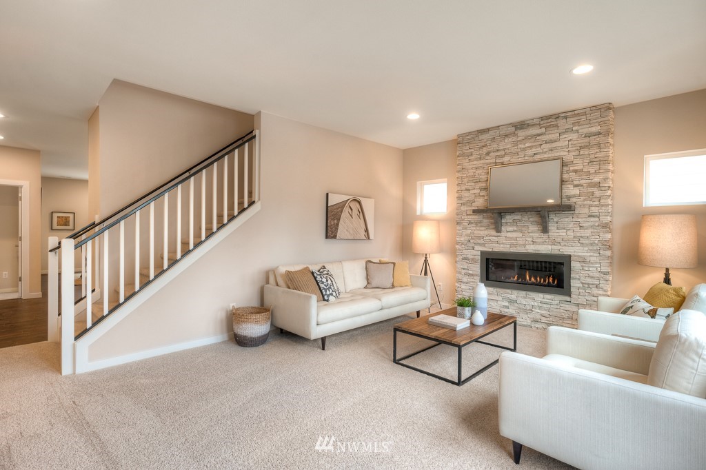 2121 228th Place Southwest, Unit EP 11 Bothell, WA 98021 - Photo 11 of 27 a living room with furniture and a fireplace