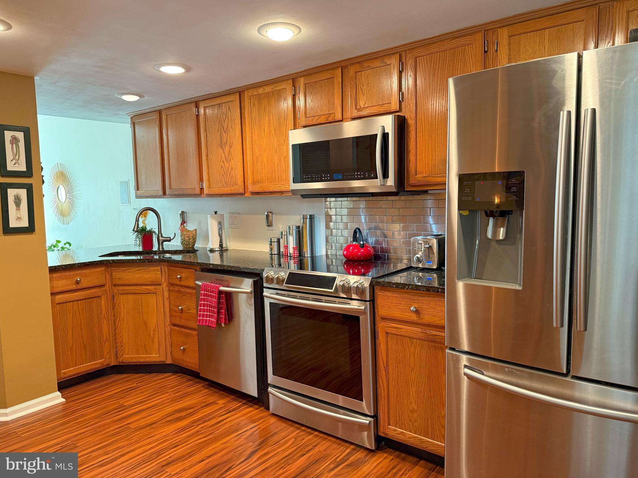 22 Chilmark Court Bear, DE 19701 - Photo 6 of 29 a kitchen with stainless steel appliances granite countertop a refrigerator stove top oven and sink