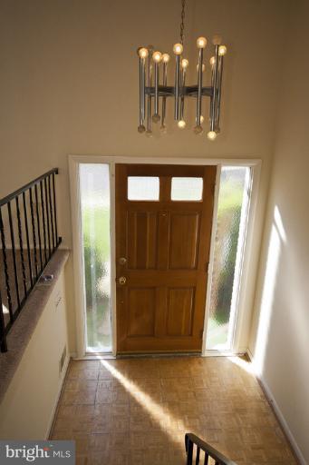 3912 Sybil Road Randallstown, MD 21133 - Photo 12 of 18 a view of hall way with dining space and chandelier