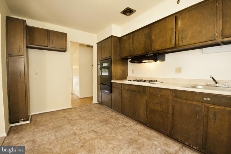 3912 Sybil Road Randallstown, MD 21133 - Photo 5 of 18 a kitchen with granite countertop a sink cabinets and stainless steel appliances