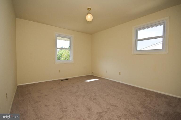 3912 Sybil Road Randallstown, MD 21133 - Photo 7 of 18 an empty room with windows