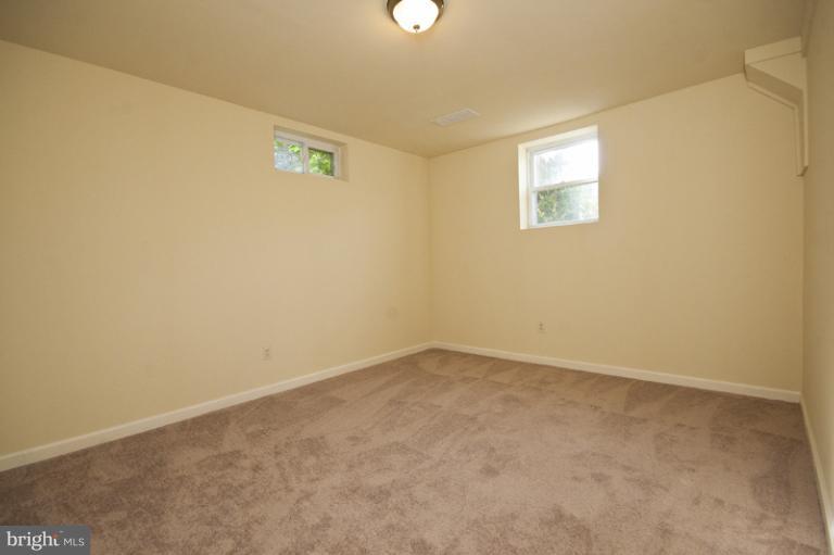 3912 Sybil Road Randallstown, MD 21133 - Photo 8 of 18 an empty room with windows