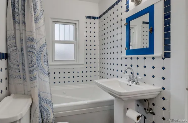 a bathroom with a bathtub and sink