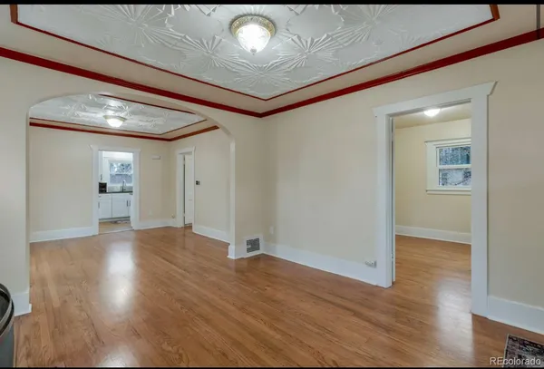 a view of an empty room and wooden floor