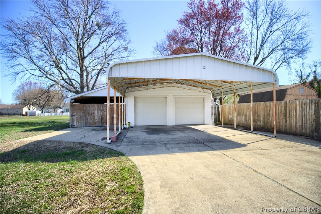 12 Old Meribeth Road Hampton, VA 23669 - Photo 4 of 32 View of side of home with a carport, a garage, and a yard