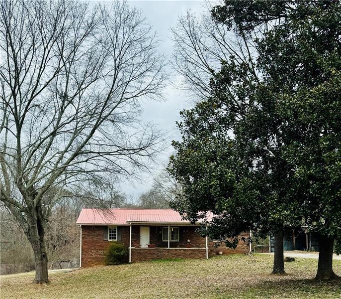 6583 Heardsville Road Cumming, GA 30028 - Photo 1 of 1 a front view of a house with garden