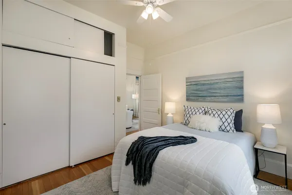 a bedroom with a bed and a ceiling fan