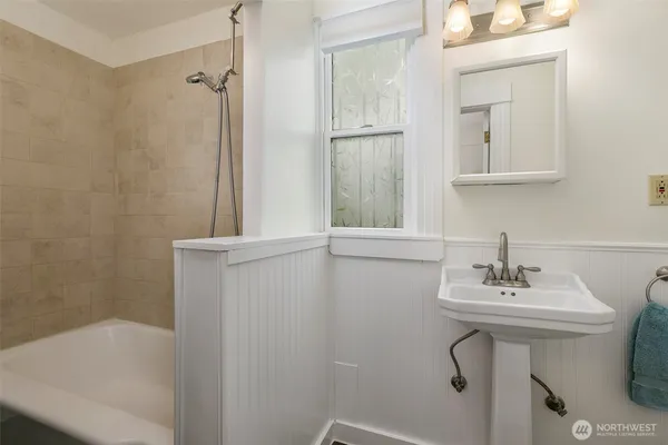 a bathroom with a sink a mirror and a bathtub