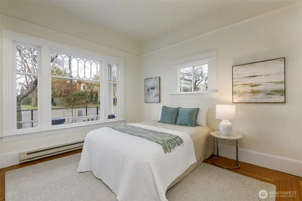 a bedroom with a large bed and a large window